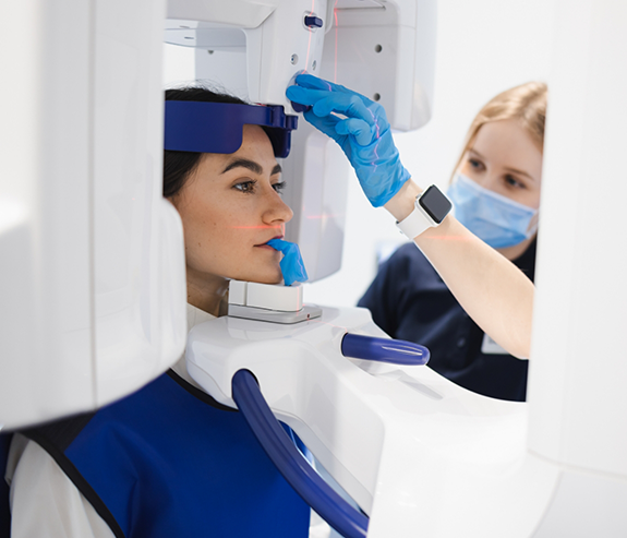 Dental patient getting a cone beam scan of her mouth and jaws