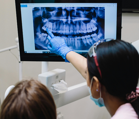 Dentist showing a patient an x ray of their teeth